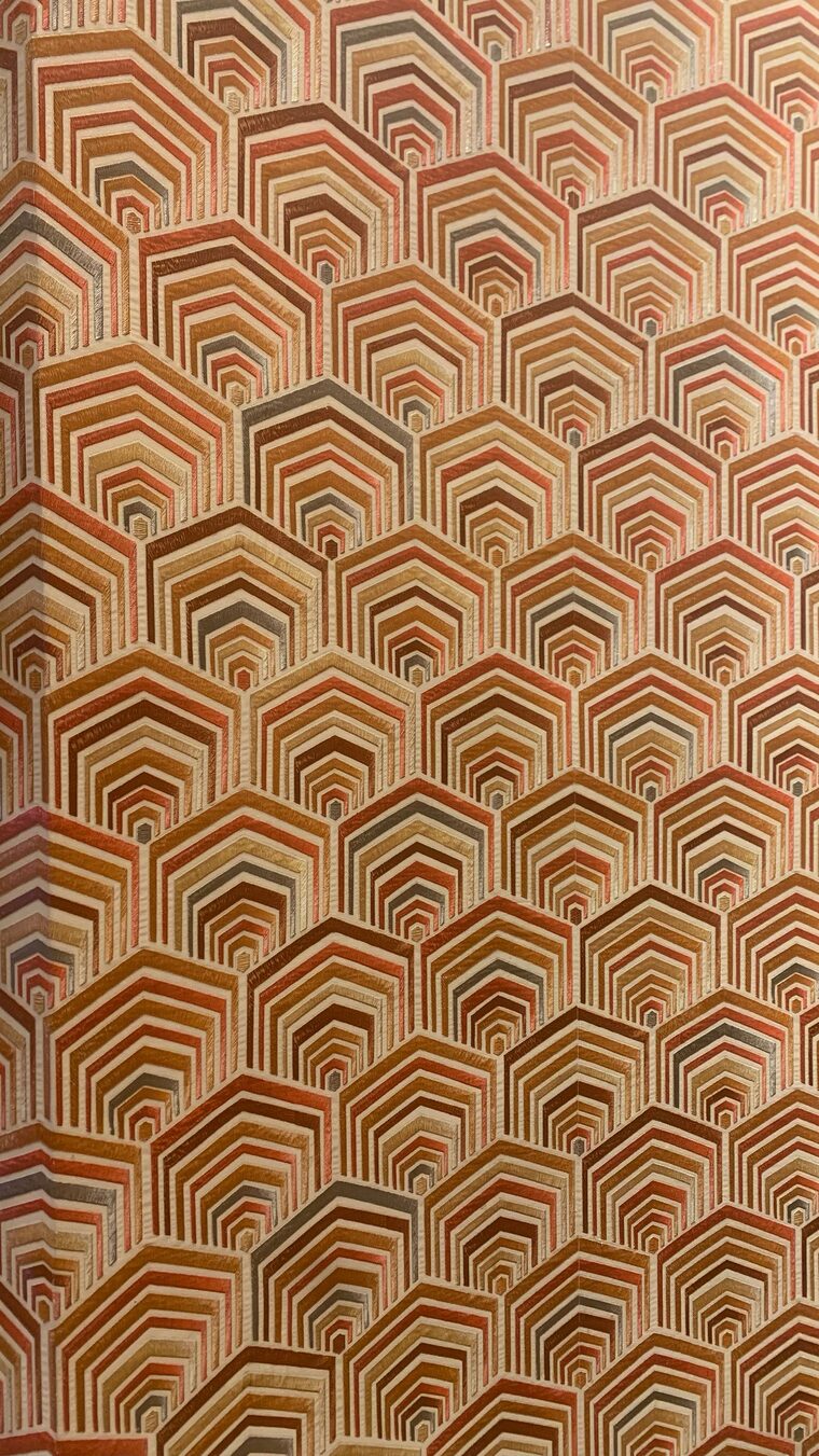 Close detail of art-deco terracotta geometric wallpaper