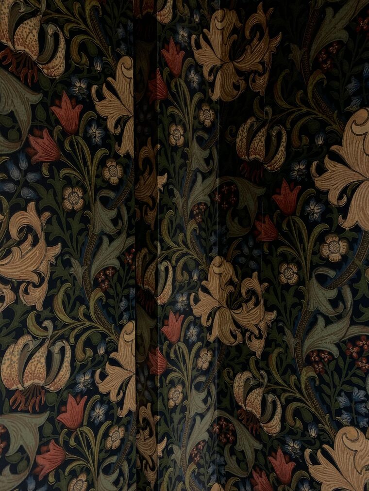 Close detail of a rich William Morris style floral wallpaper